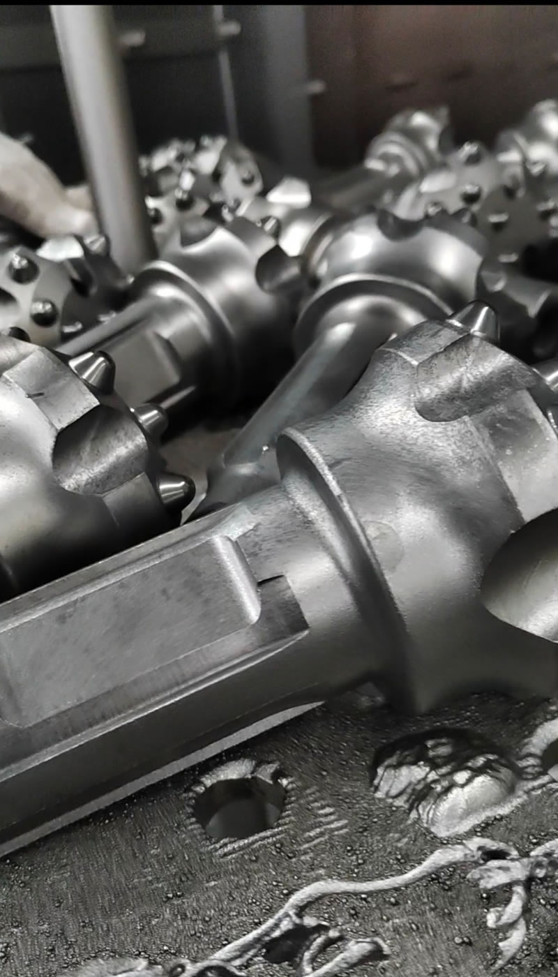 Surface shot blasting treatment for dth rock drilling bits